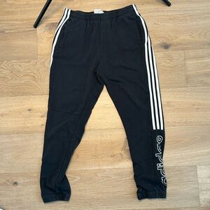 Slightly faded black adidas sweat pants
